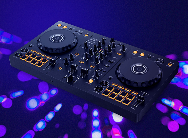 Modern DJ controller with dual jog wheels, illuminated orange pads, faders, and knobs on a dark purple background with abstract blue and pink light patterns.
